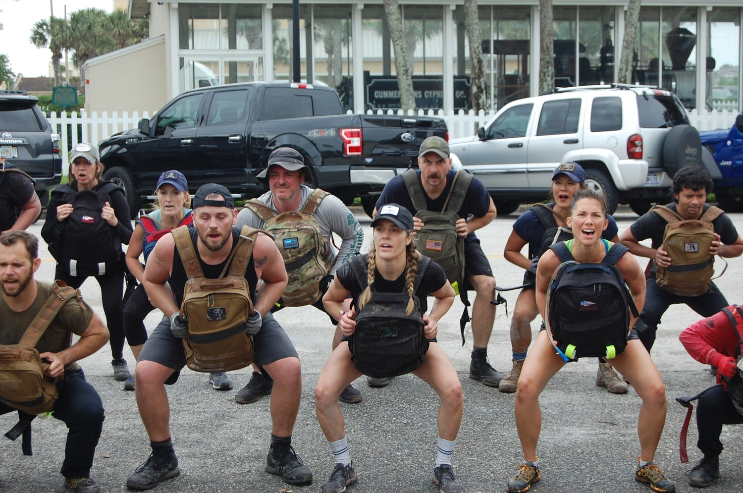 Group of people doing outdoor rucking workout with GORUCK backpacks