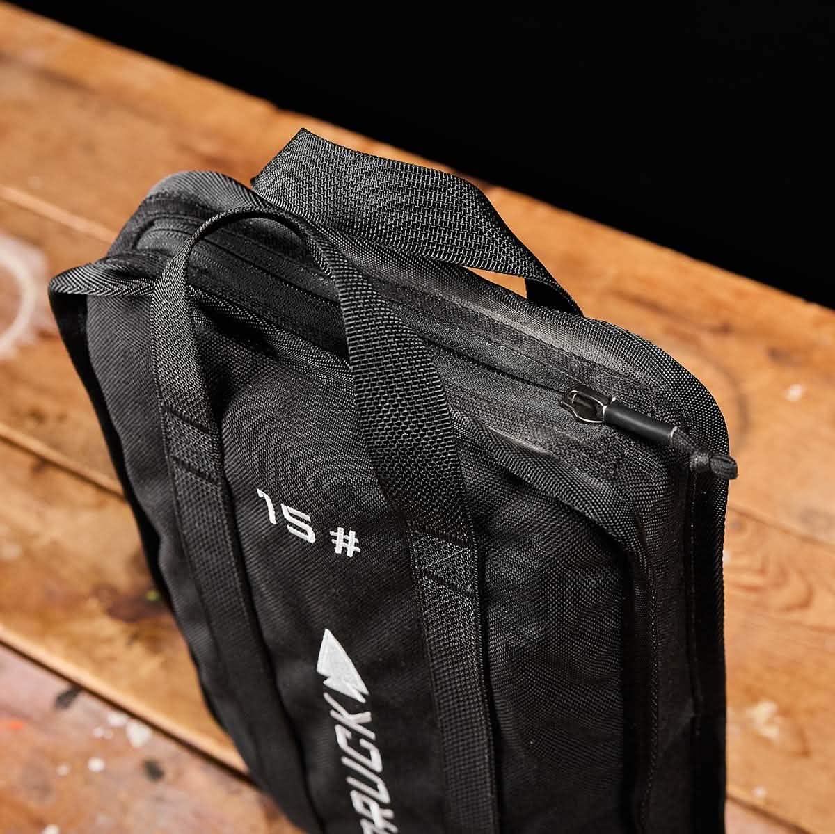 GORUCK 15lb black ruck weight on wooden floor, durable handles, tactical fitness gear