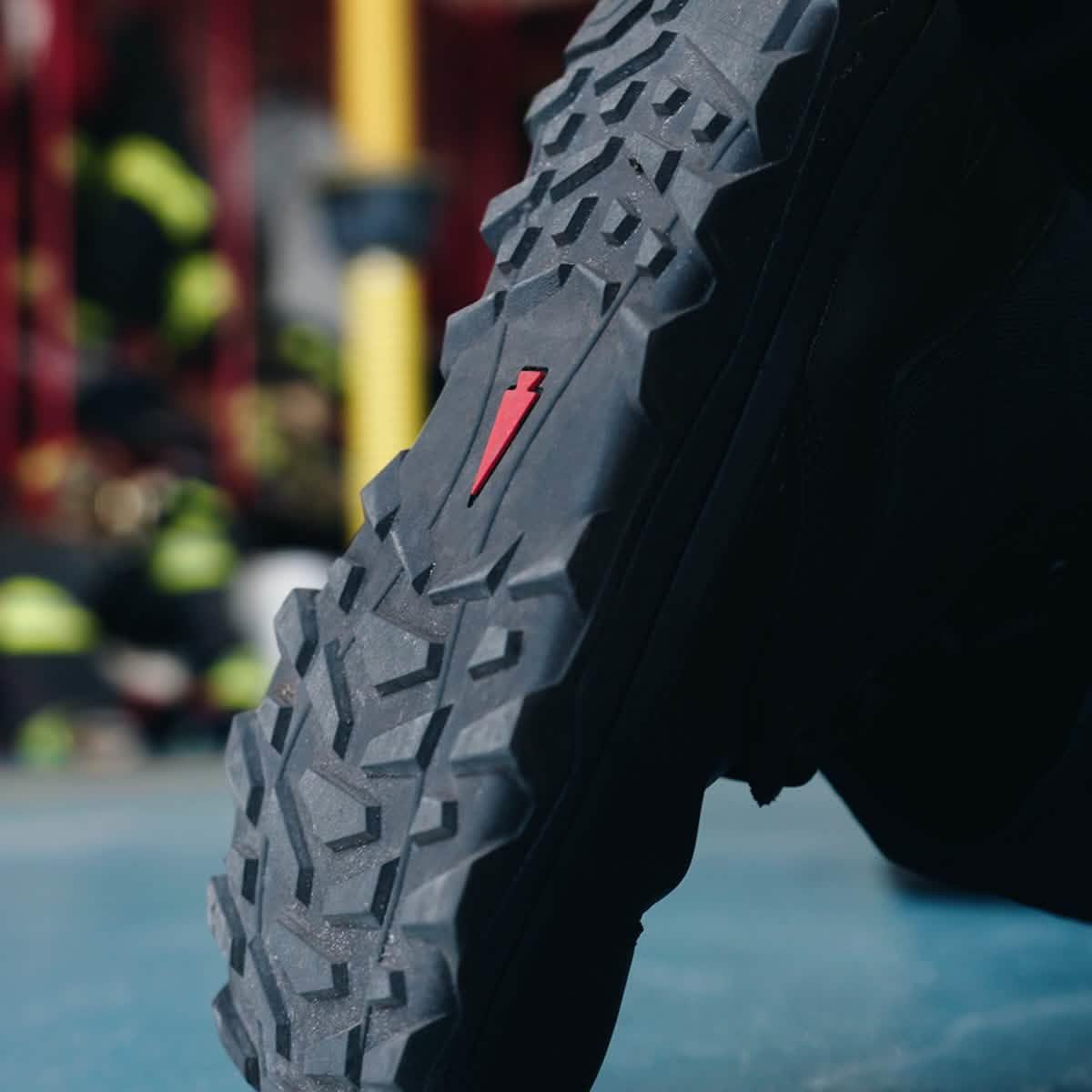 Close-up of GORUCK rucking shoe sole with rugged tread and red lightning bolt logo