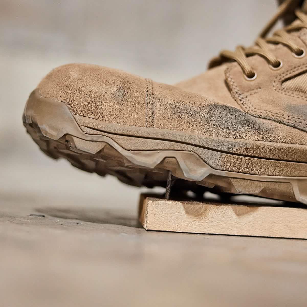 GORUCK tan rucking boot tested for puncture resistance on a nail through wood