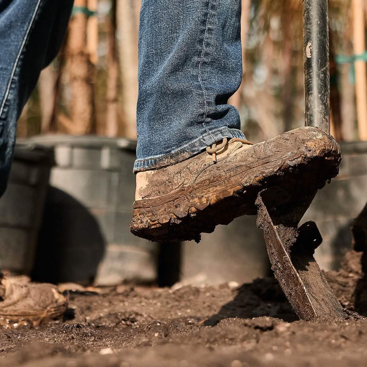 GORUCK rucking boot in muddy outdoor setting with shovel and jeans