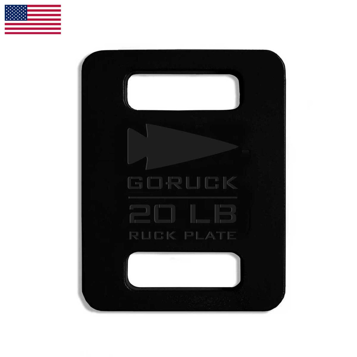 The Basic Rucker + FREE Plate is a black rectangular 20 LB ruck plate for weighted training or rucking, featuring two slots, an arrow logo, and a small US flag in the corner.