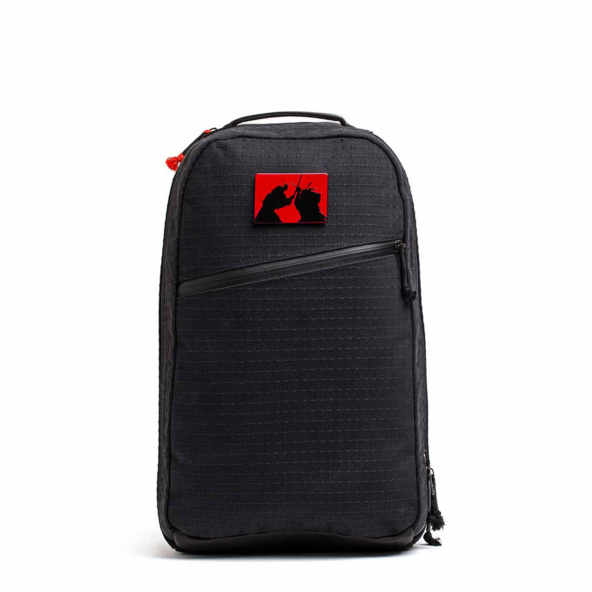 Black backpack featuring a red patch with two black unicorn silhouettes, inspired by the limited-edition Bullet Ruck x Carryology - GRXC2 Samurai 2.0’s Black Samurai Sashiko style.
