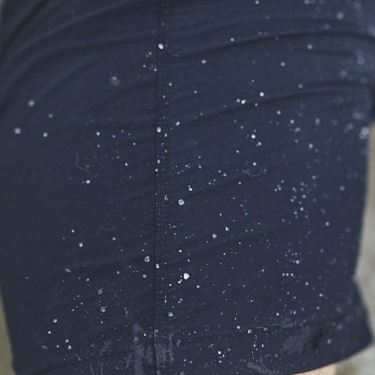 Close-up of GORUCK Challenge Short in navy with water droplets showing water resistance.