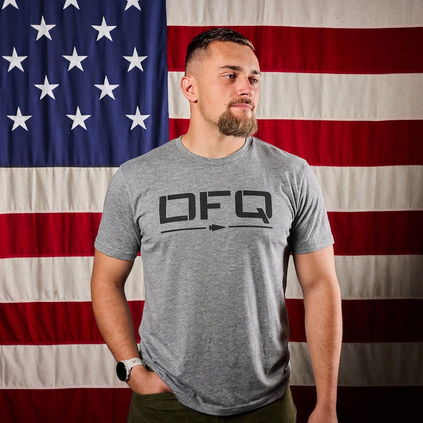 A man wearing the DFQ Tee - Tri-BlendX, a gray premium blend t-shirt with