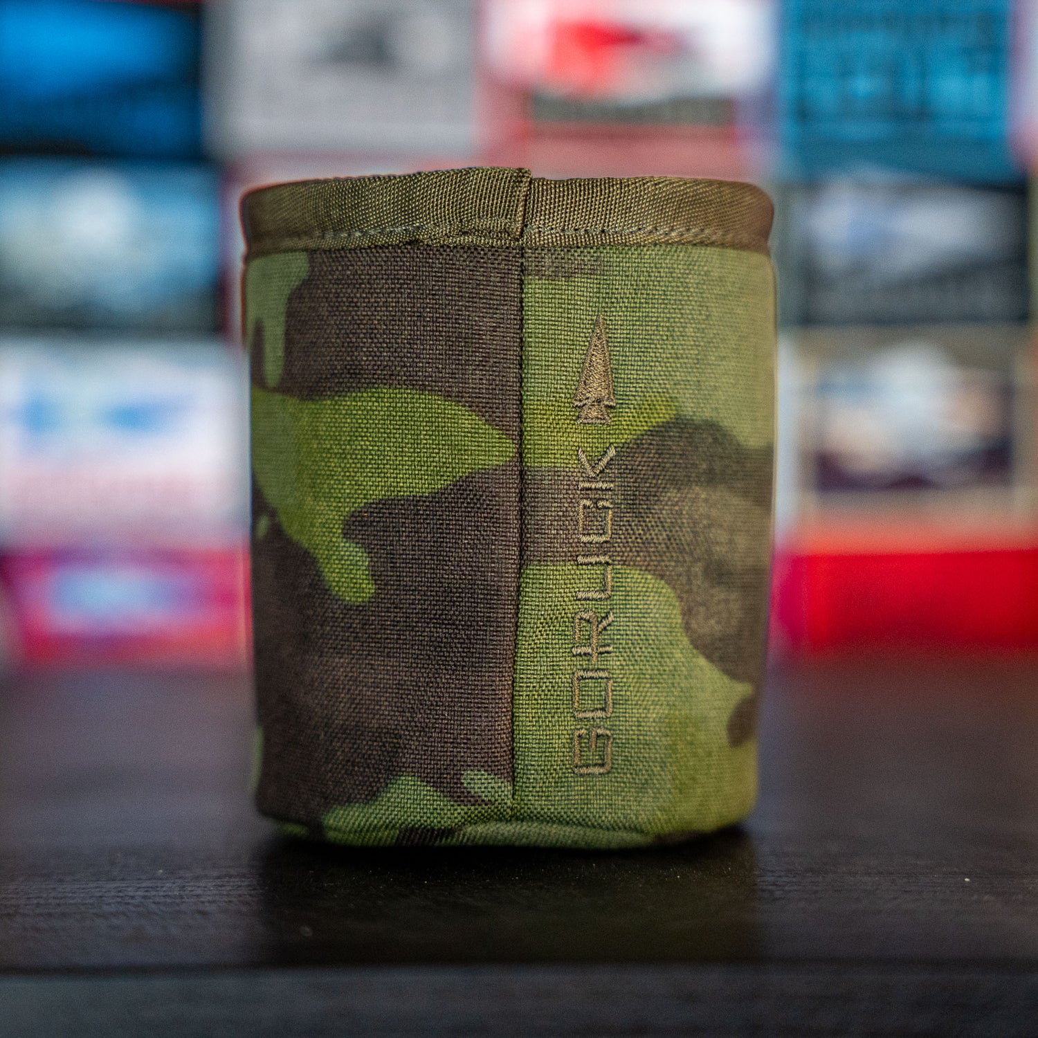 The Ballistic Beer Jacket features a camouflage pattern with a vertical arrow and