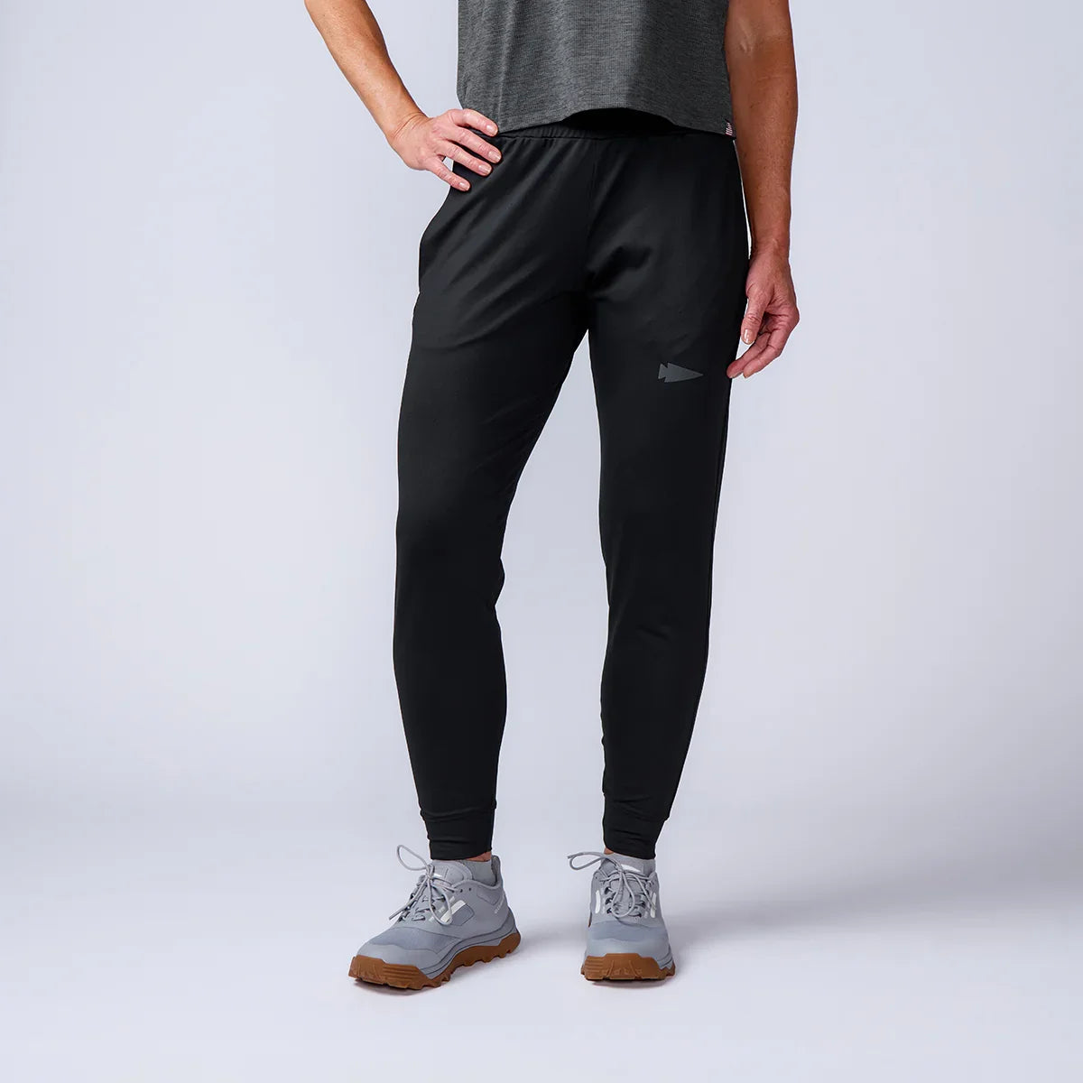 GORUCK black athletic joggers with logo, worn by model, studio background