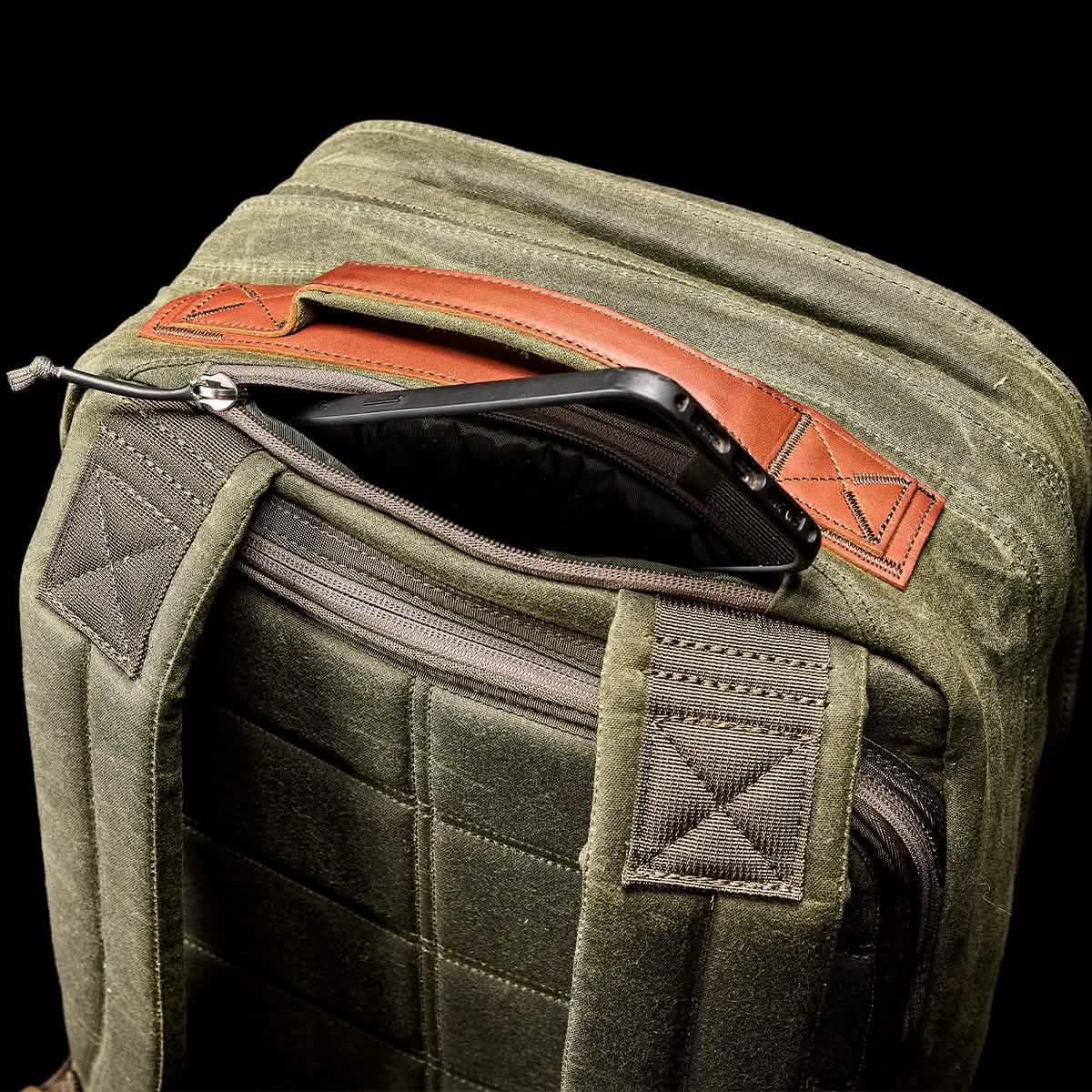 GORUCK olive green rucksack with phone pocket and rugged straps, durable rucking gear