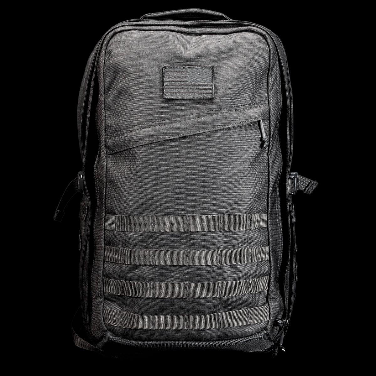 GORUCK black tactical rucksack with patch, durable nylon, and MOLLE webbing on black background.