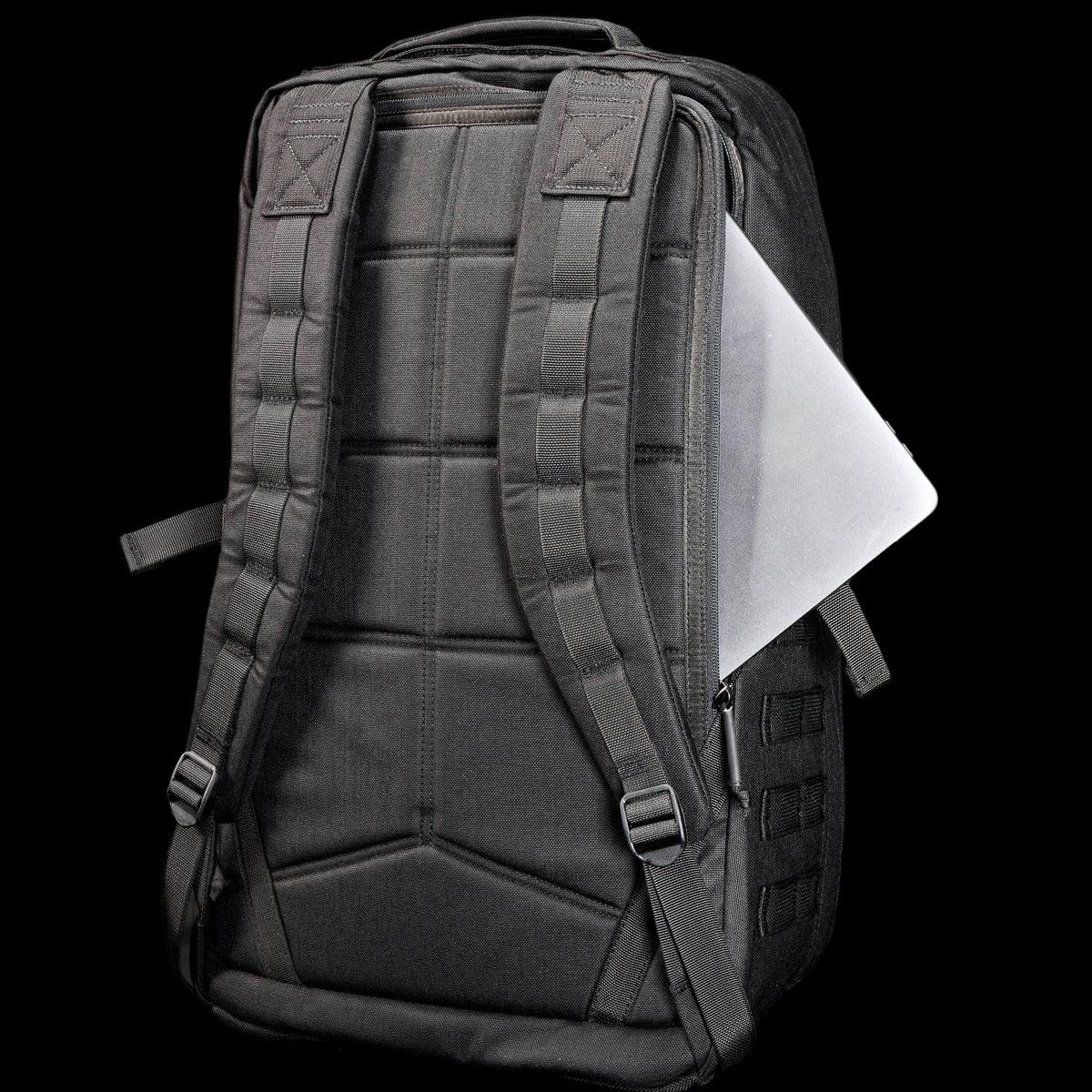 GORUCK black rucksack with padded straps and a laptop partially in back pocket