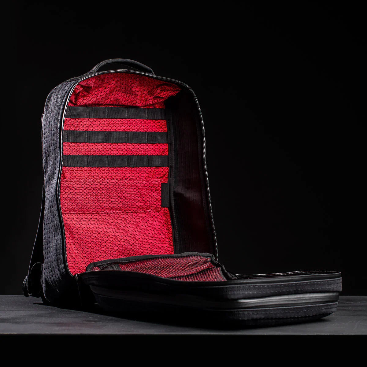 GORUCK black rucksack open to show red patterned interior and organization straps