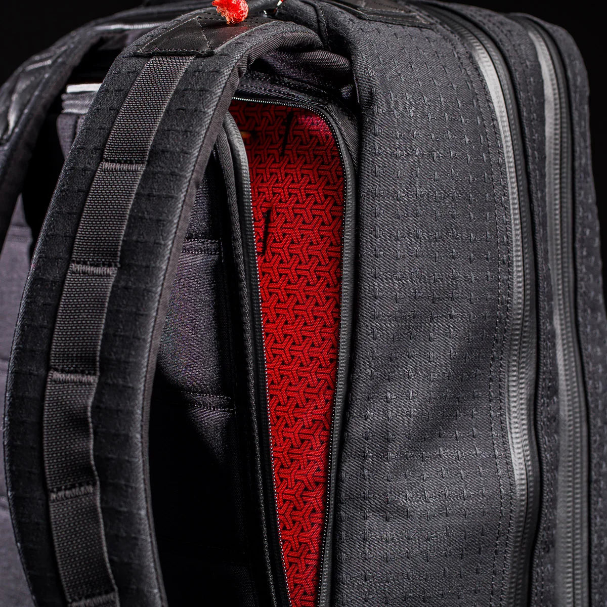 GORUCK black rucking backpack closeup showing red patterned interior and sturdy straps