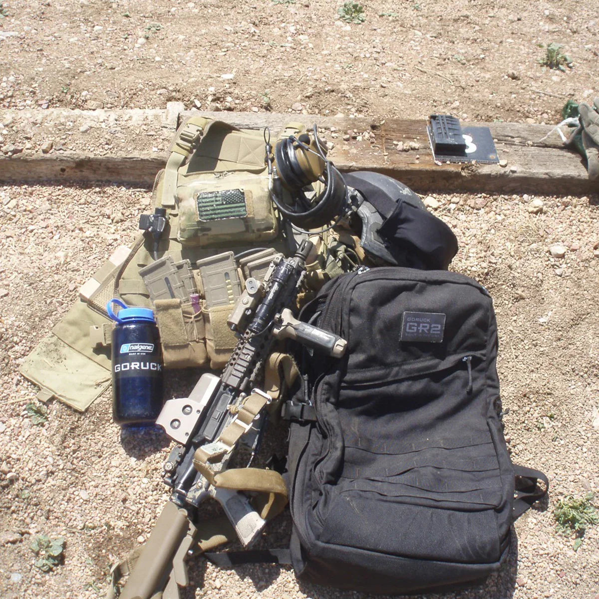 GORUCK GR2 black backpack outdoors with tactical gear, water bottle, and training equipment