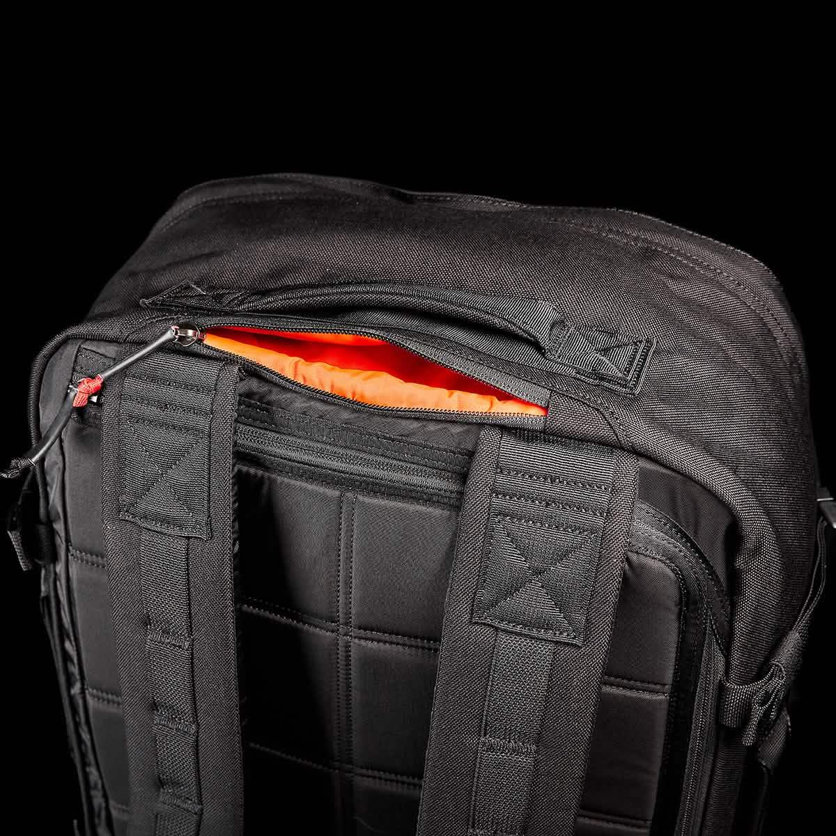 GORUCK black rucksack with padded straps and orange-lined zip pocket, durable rucking gear