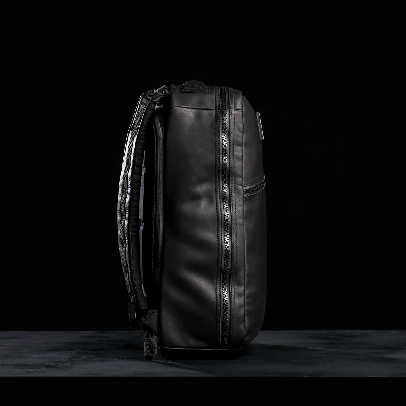 GORUCK black leather rucksack side view with rugged zipper, durable rucking gear