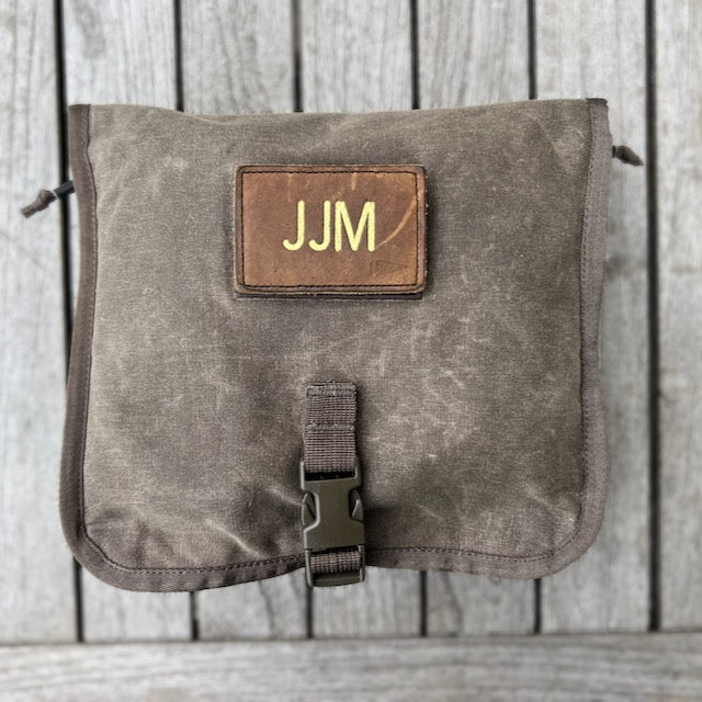 The Wire Dopp - Waxed Canvas pouch, featuring a leather