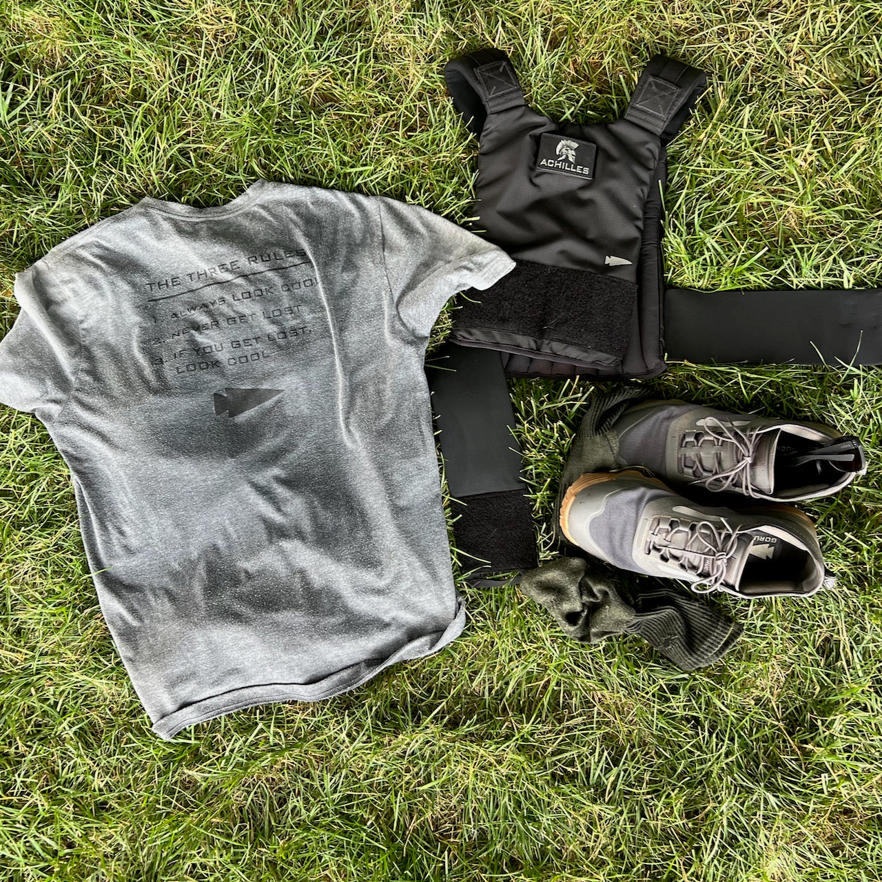 Three Rules Tee - Unisex Tri-BlendX in gray, black weighted vest, leggings, socks, and black shoes on grass—train or explore outdoors with cool style and confidence.