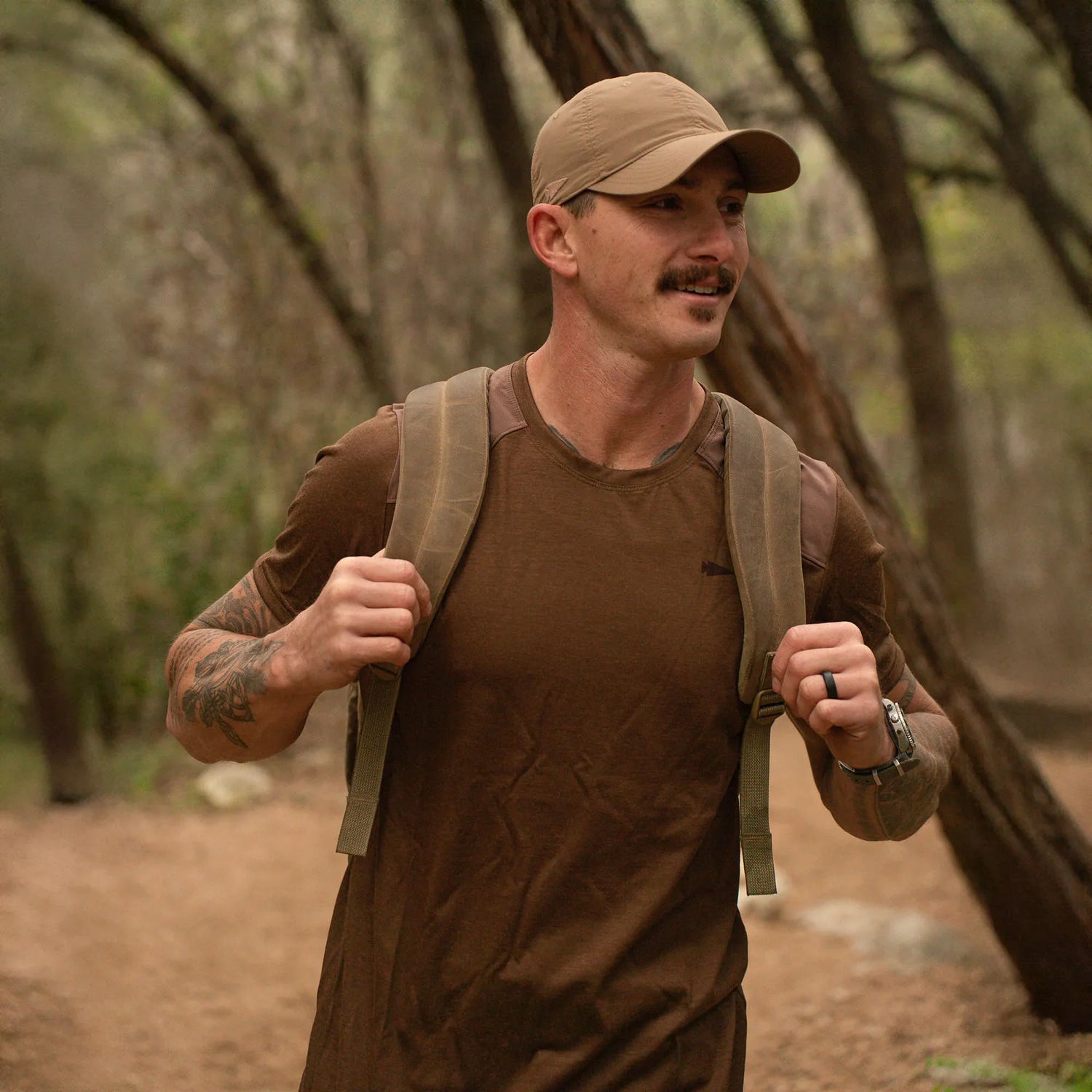 Man wearing GORUCK rucking gear, hiking with backpack on forest trail