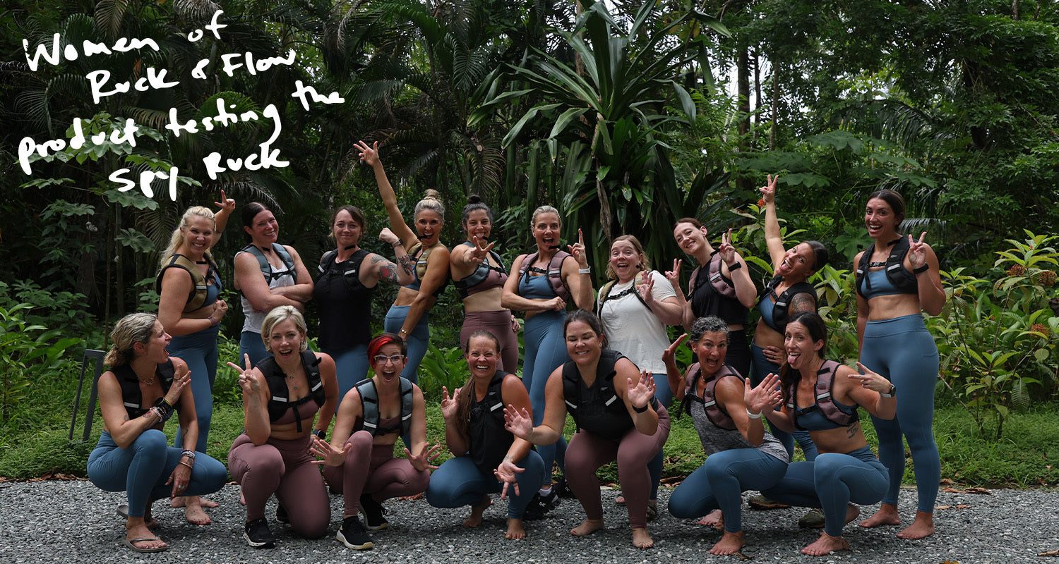 A group of women in athletic wear posing together outdoors with greenery in the background. Handwritten text present.