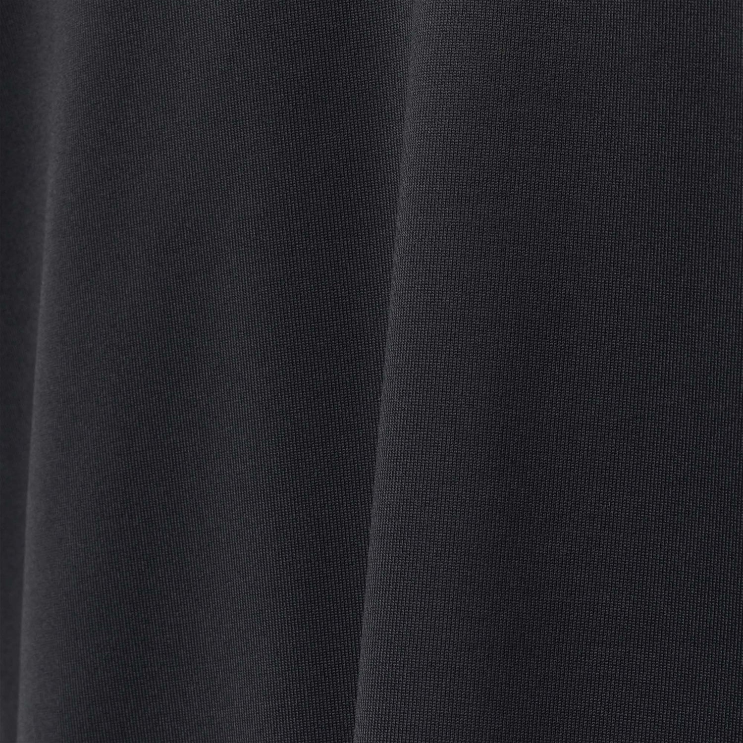 A close-up of black EnduraKnit fabric with visible texture and gentle folds showcases the durable quality of the Men's Long Sleeve Rucking Polo, ideal for rucking activities.