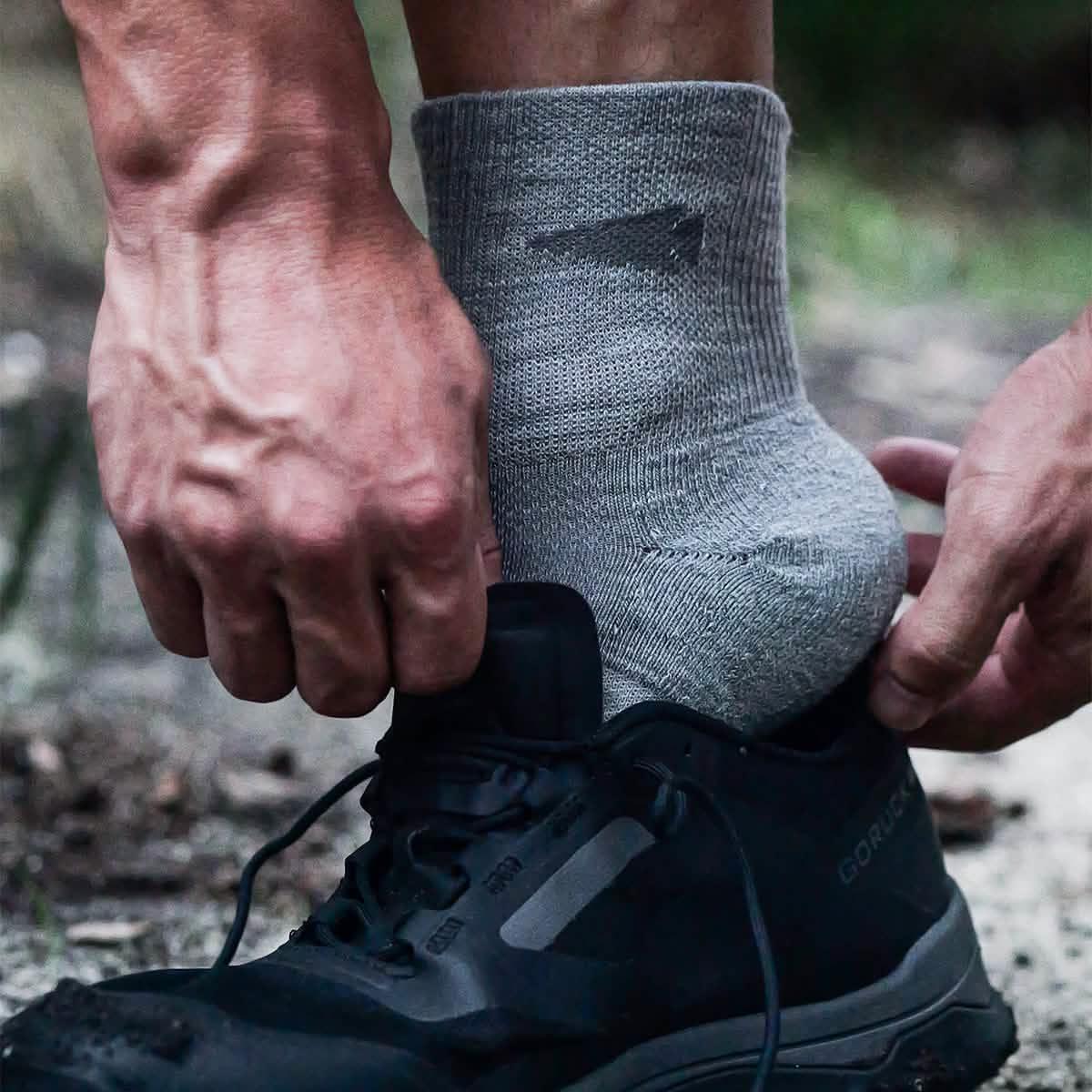 GORUCK Trail Merino Sock in charcoal being worn with black rucking shoe outdoors