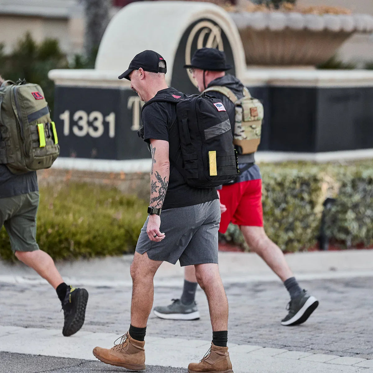 Group of people rucking in GORUCK backpacks and athletic apparel outdoors