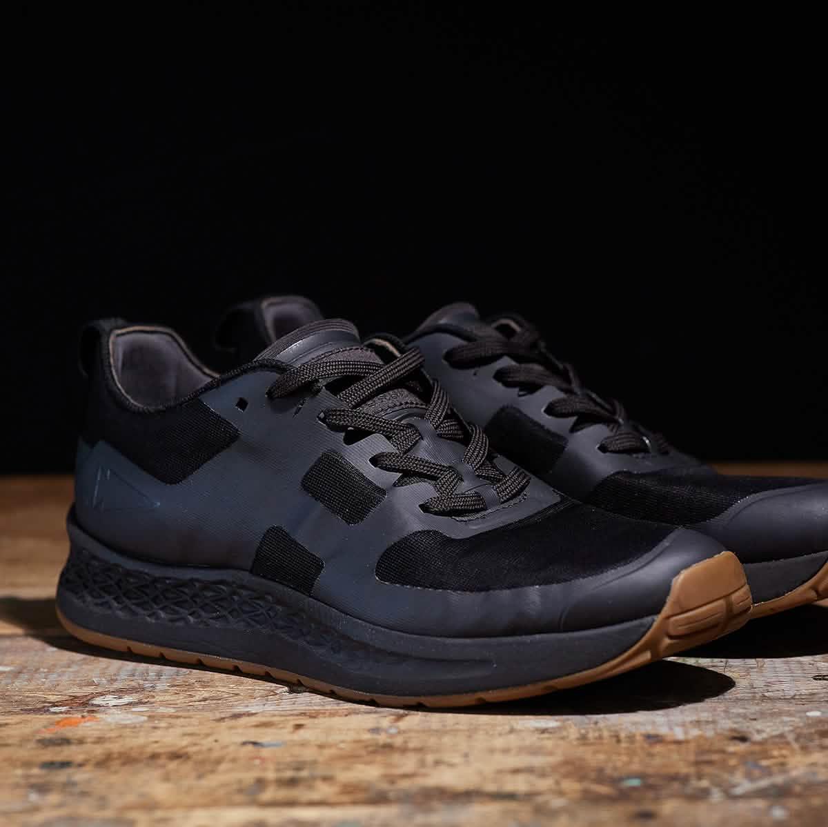 GORUCK black rucking shoes with gum sole on wooden surface, rugged athletic footwear
