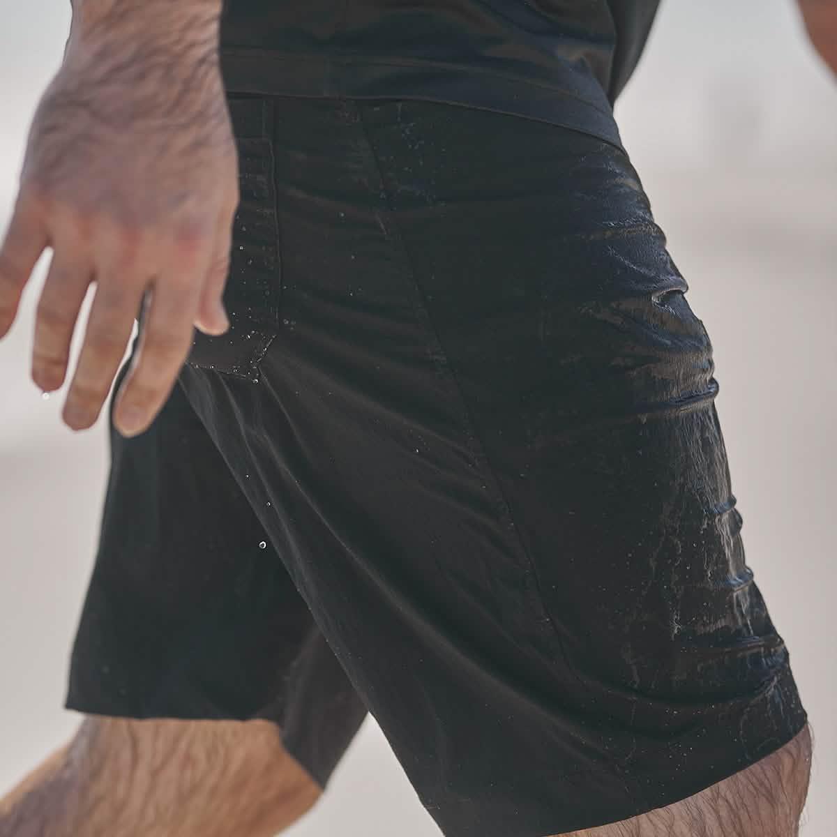 GORUCK durable black rucking shorts wet outdoors, close-up view of fit and fabric