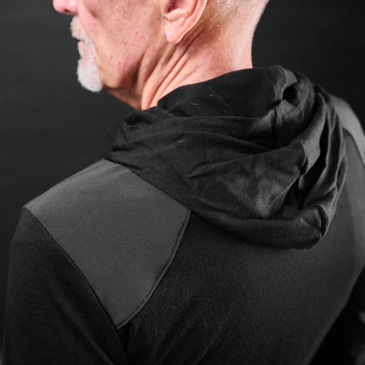 GORUCK black hoodie with reinforced shoulder panel, worn by man, close-up on back