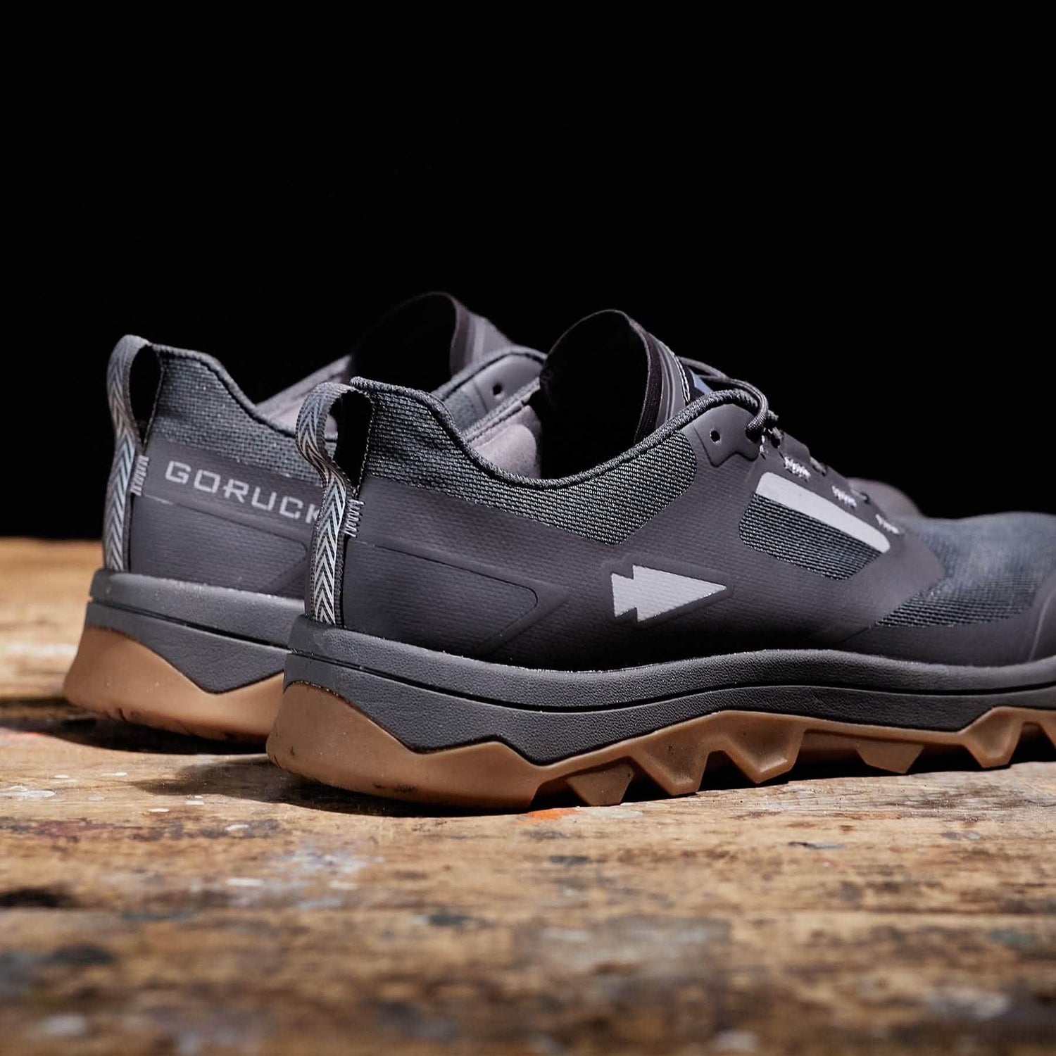 GORUCK black rucking shoes with rugged soles on a wooden surface, side and heel view