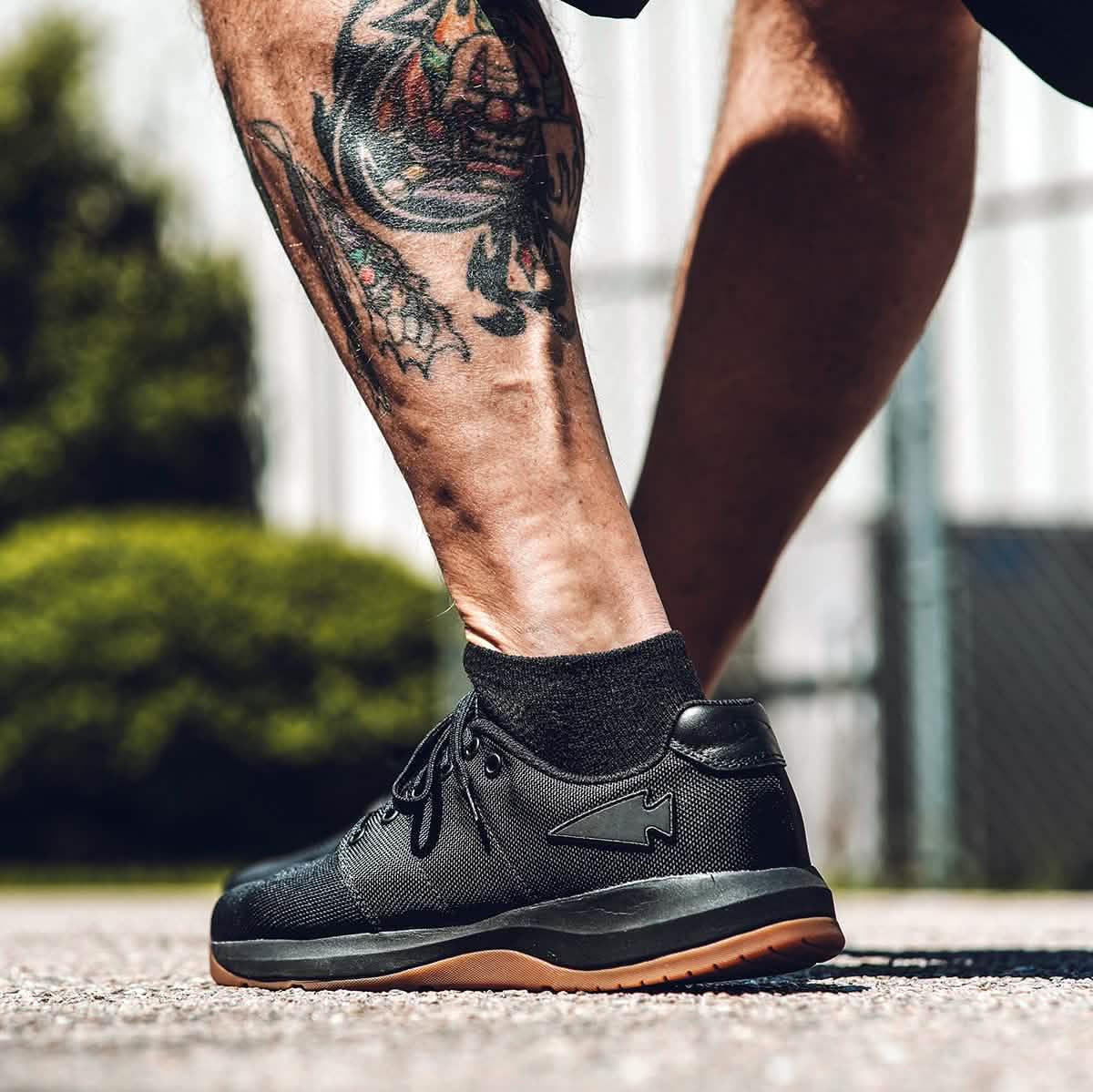 GORUCK black rucking shoe on tattooed leg outdoors, durable footwear for rucking gear