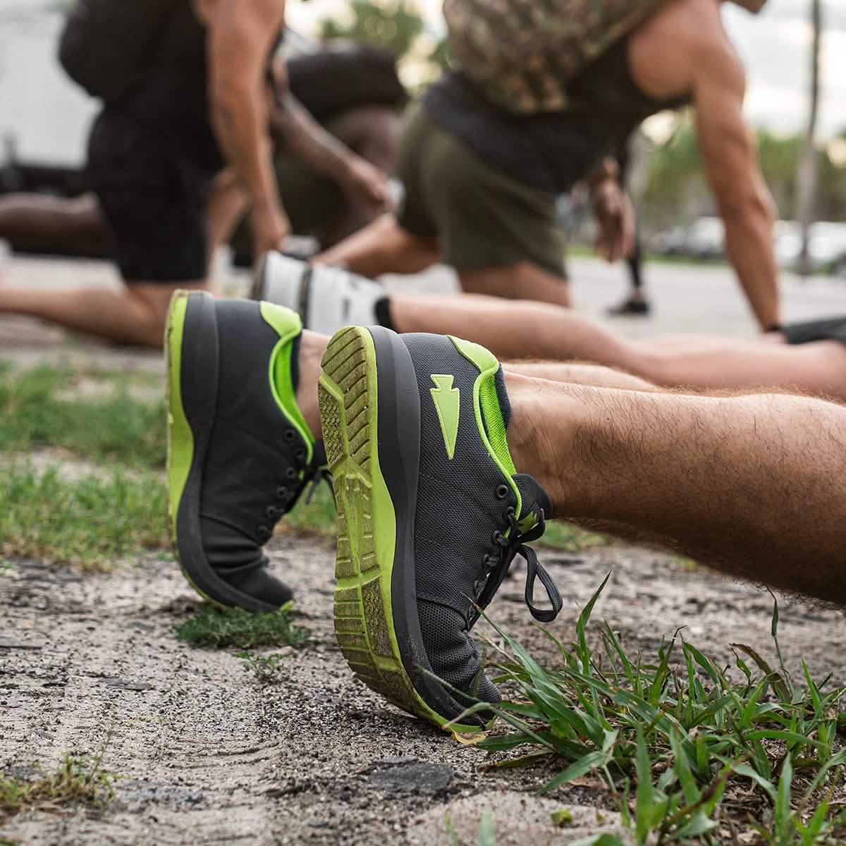 GORUCK men’s black and green training shoes worn outdoors during group rucking workout