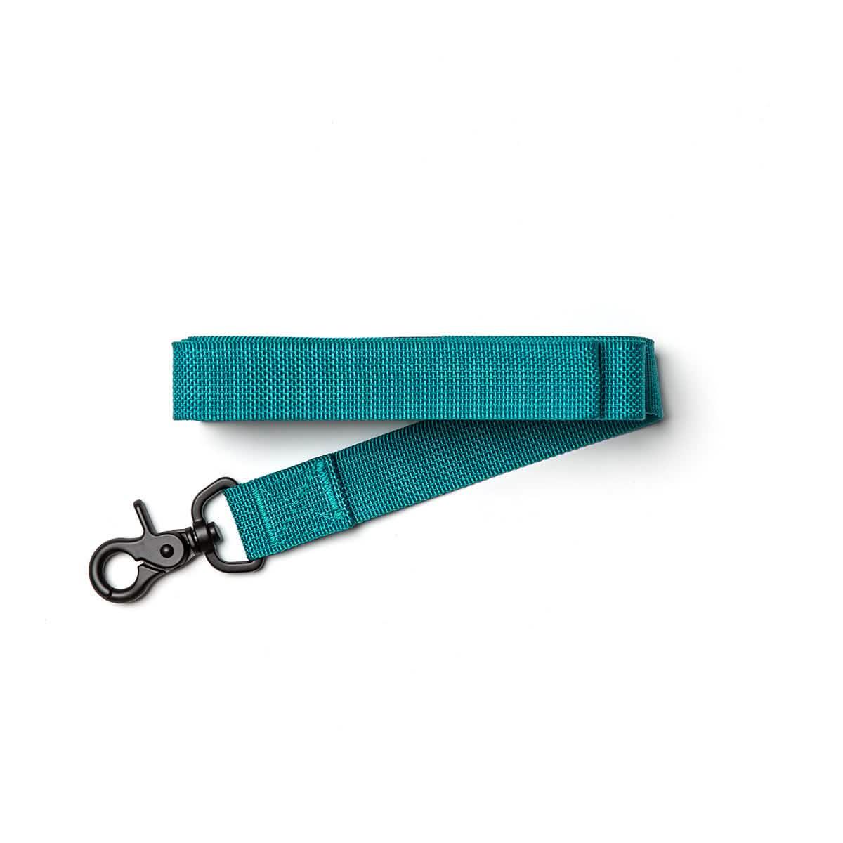 Teal GORUCK gear strap with black metal clip on white background