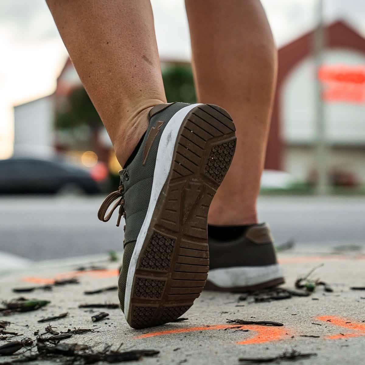 GORUCK women's rucking shoe on sidewalk, close-up of sole and outdoor urban setting