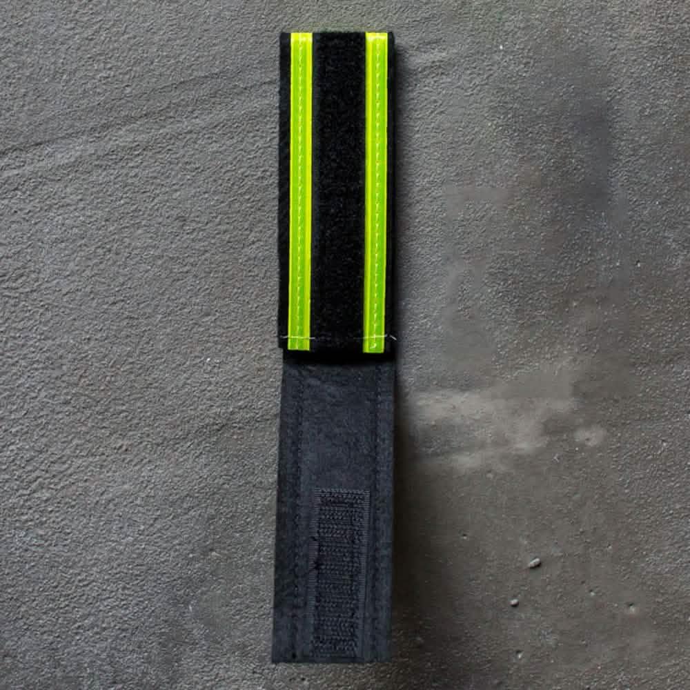 GORUCK reflective ruck band with velcro, black and neon yellow, on concrete surface
