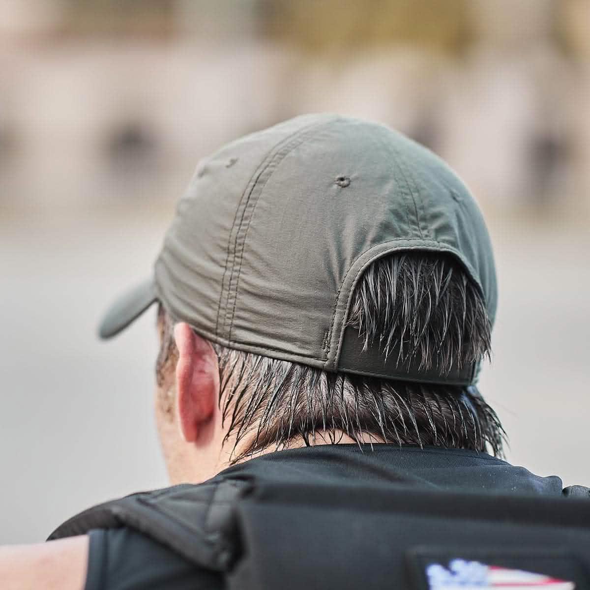 GORUCK performance tac hat back detail on a person with wet hair outdoors