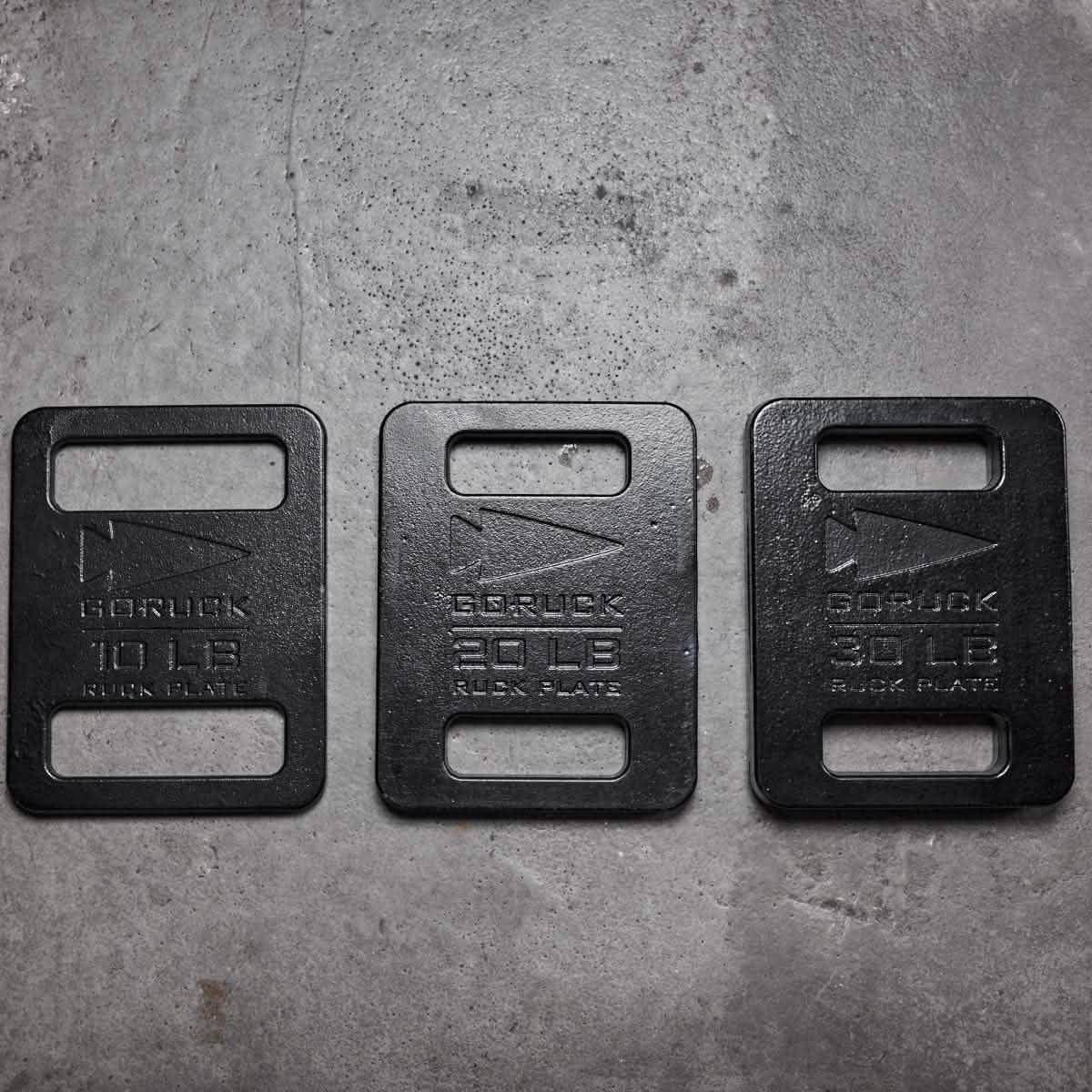 GORUCK ruck plates 10lb, 20lb, and 30lb weights on concrete floor