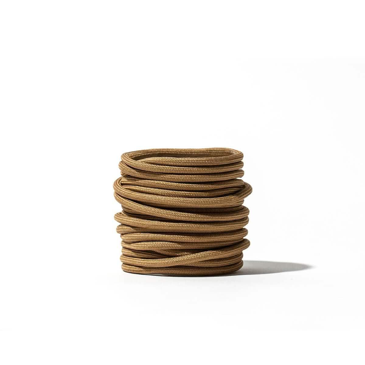 Coiled coyote brown GORUCK speed laces on a white background, durable rucking gear accessory