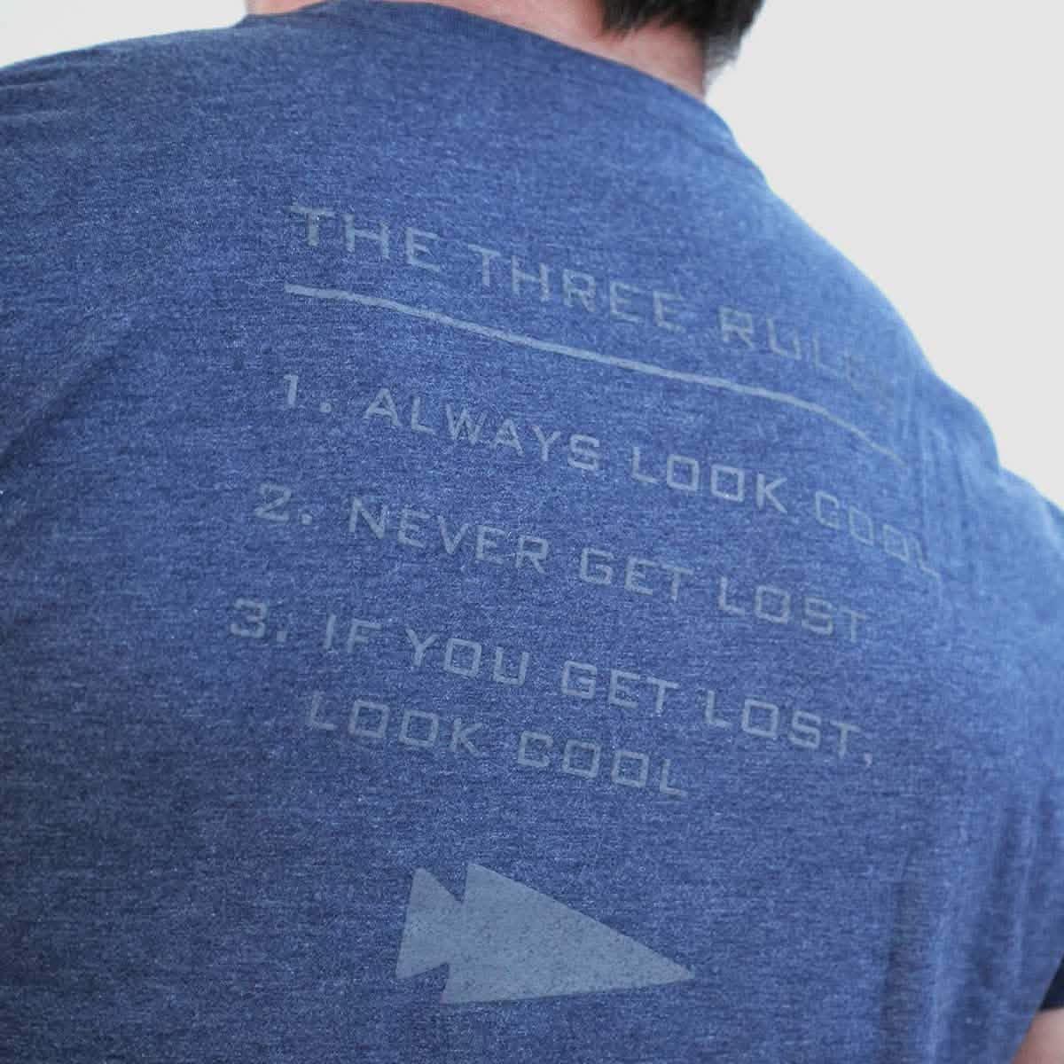 GORUCK blue shirt back with 'The Three Rules' text: always look cool, never get lost, look cool if lost.