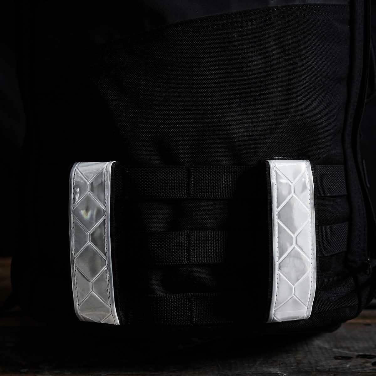 GORUCK black ruck sack with two white reflective MOLLE straps for rucking gear