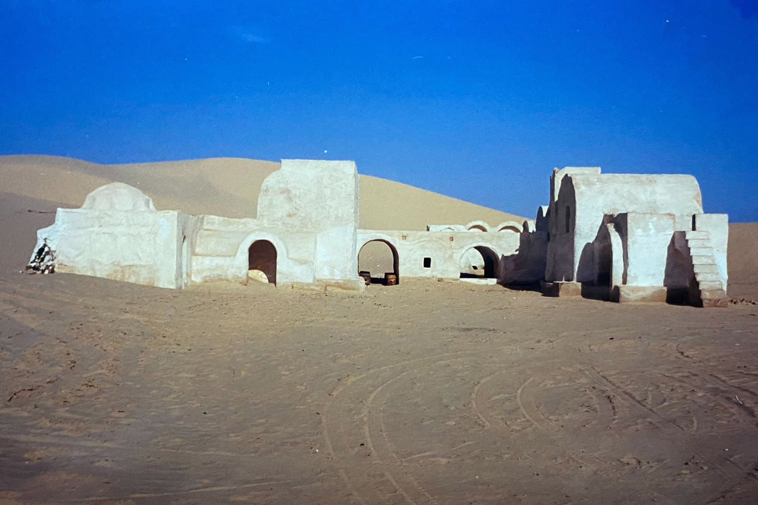 Desert ruins with white buildings and blue sky, ideal backdrop for rugged GORUCK gear adventures.