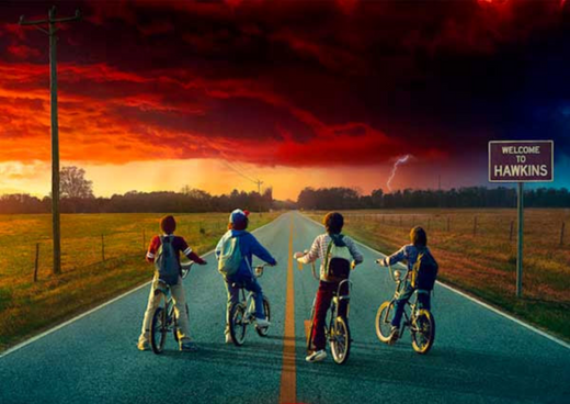Four kids on bikes face a stormy sunset in Hawkins, open road, adventure atmosphere.