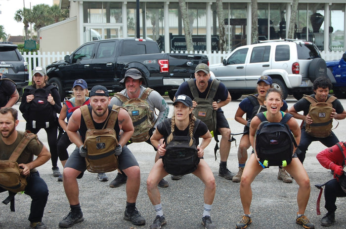 Group of people doing outdoor rucking workout with GORUCK backpacks