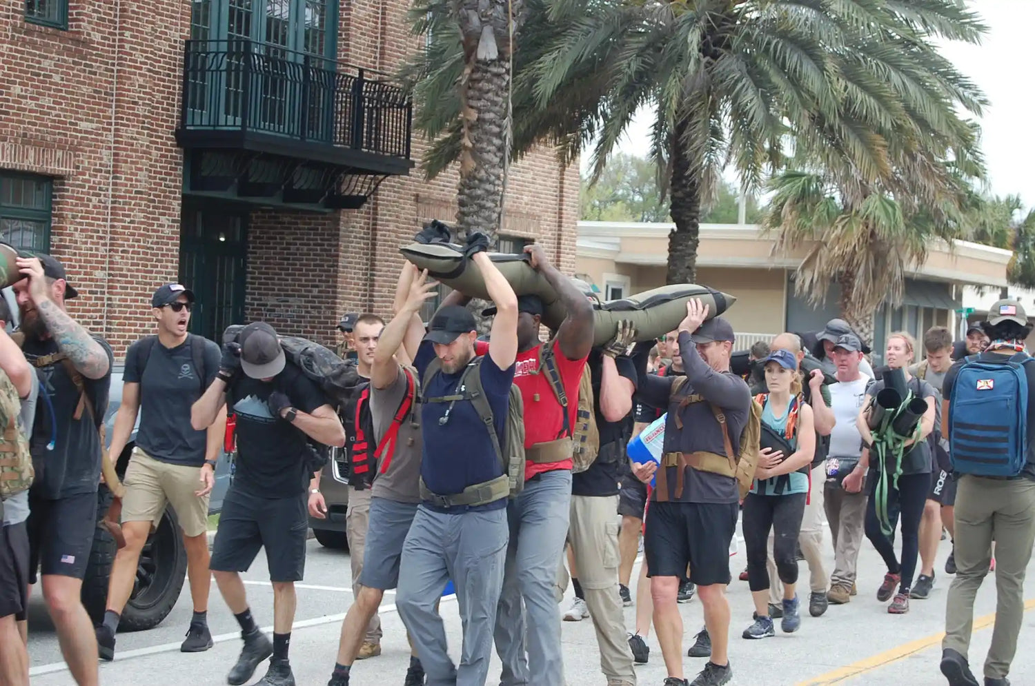 GORUCK team ruck event participants carrying weighted sandbags outdoors