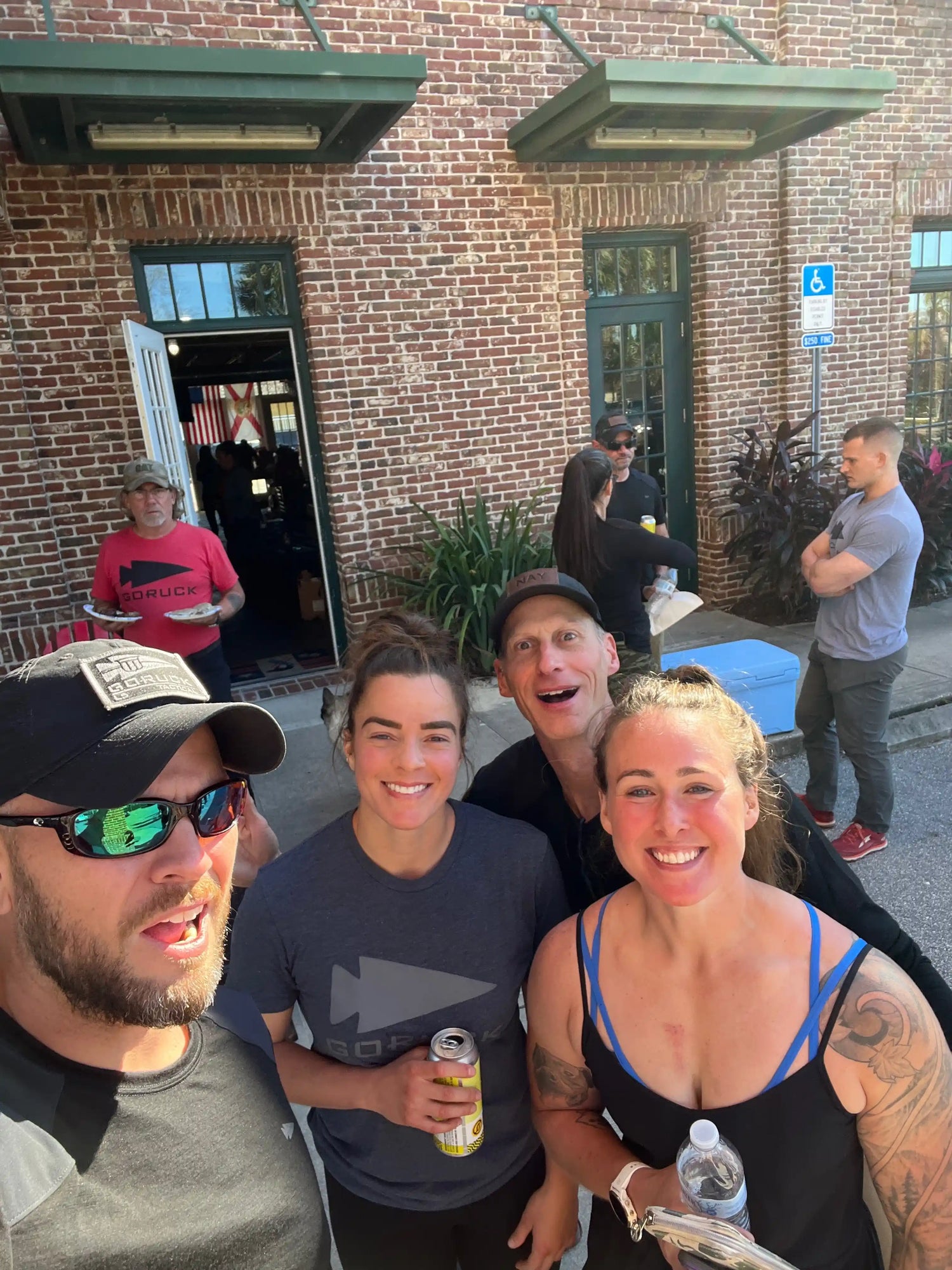 GORUCK team members smiling outside brick building during rucking event