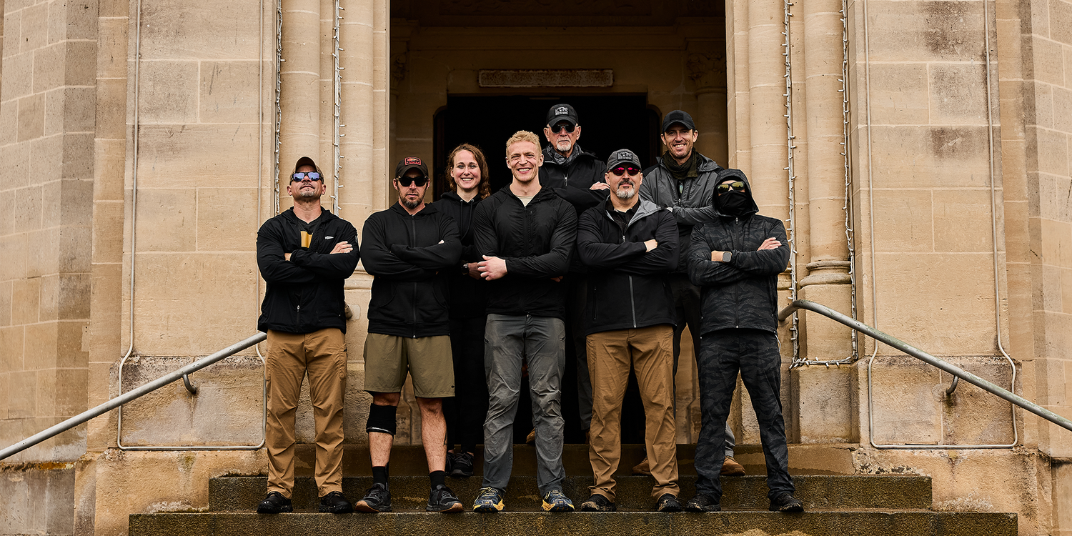GORUCK team standing together in rucking gear on stone building steps