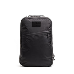 The GR1 USA - Waterproof X-PAC is a black rectangular backpack with a top handle and diagonal front zipper, shown against a white background.