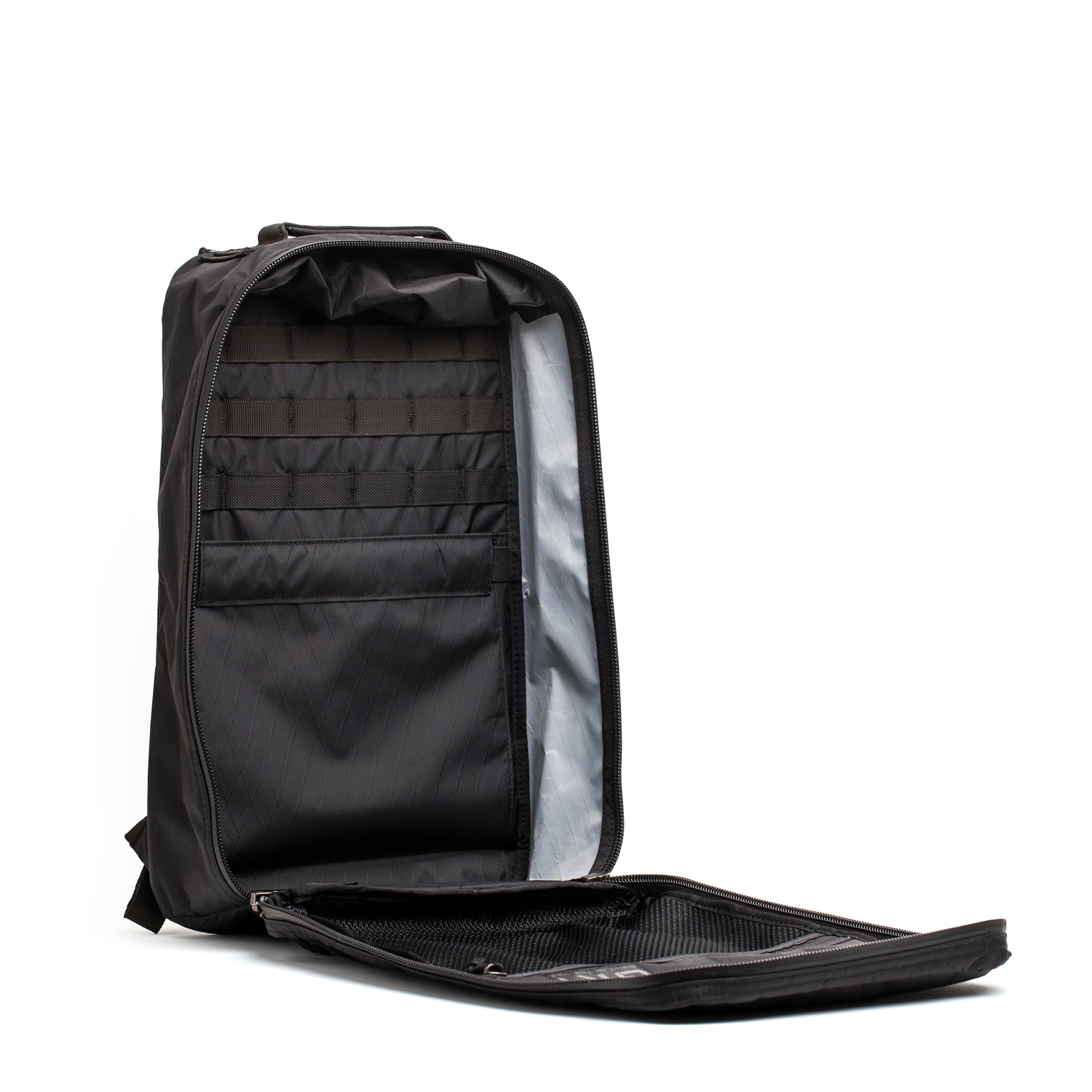 The GR1 USA - Waterproof X-PAC rucksack stands upright with its main compartment unzipped, revealing multiple interior pockets—an ultra-durable, waterproof backpack designed for everyday adventures.