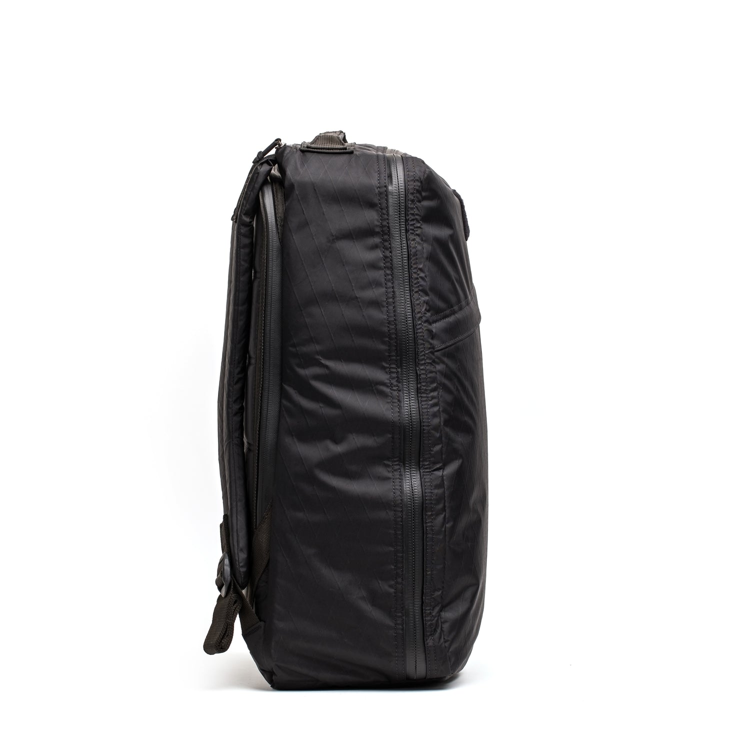 The GR1 USA - Waterproof X-PAC backpack, shown upright and side-on against a white background, is a black rucksack ideal for carrying and protecting your durable gear.