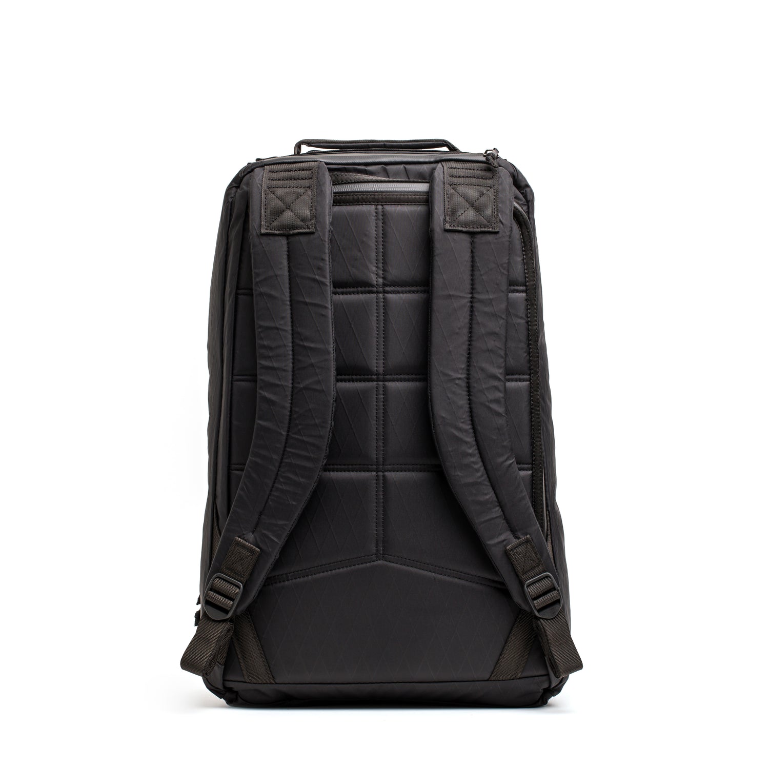 The GR1 USA - Waterproof X-PAC backpack in black is shown from the back, highlighting its padded shoulder straps, quilted design, and rugged waterproof construction.